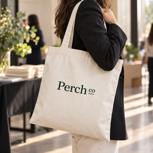 Branded shoulder tote bag carried at an event