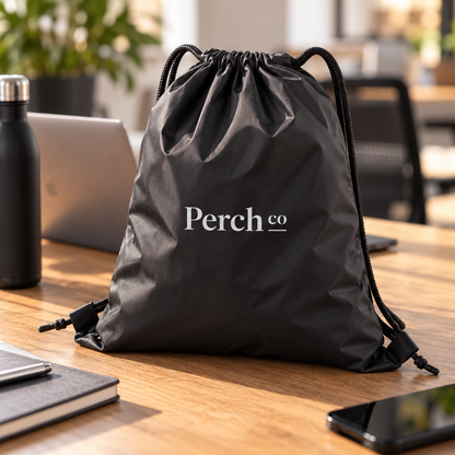 Branded black drawstring bag on an office desk