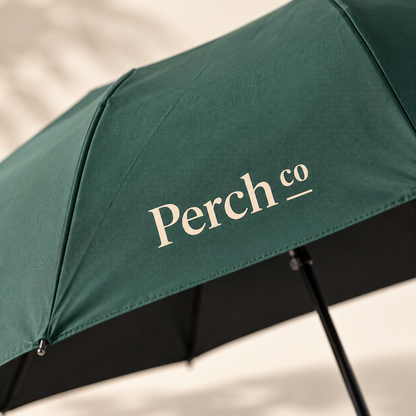 Close-up of the printed logo on the green umbrella canopy