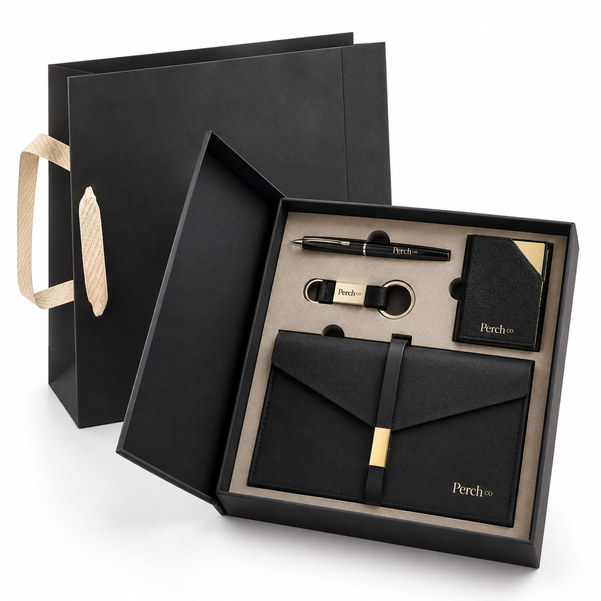Four-piece pocket and desk gift set in an open black gift box with matching carry bag