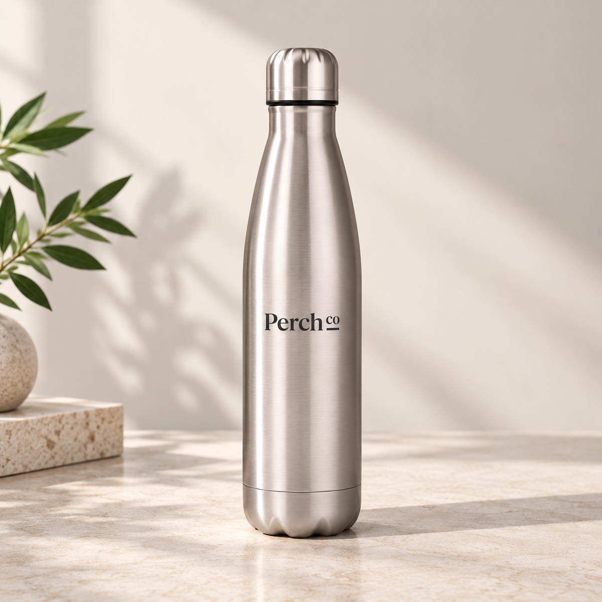 Perch Co branded 500ml contour water bottle in a brushed finish on a stone benchtop