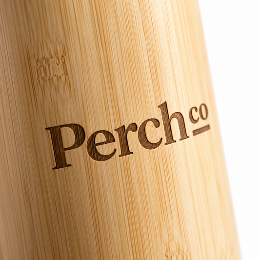 Close-up of the Perch Co logo engraved into the bamboo of a slim flask