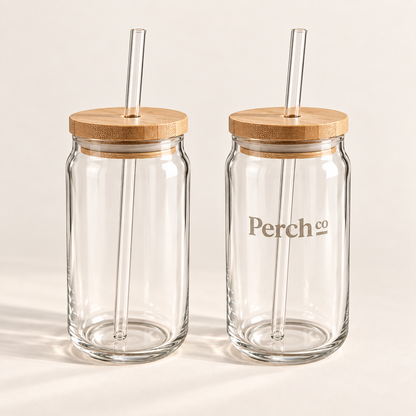 Two glass can tumblers with bamboo lids and glass straws, one branded with the Perch Co logo