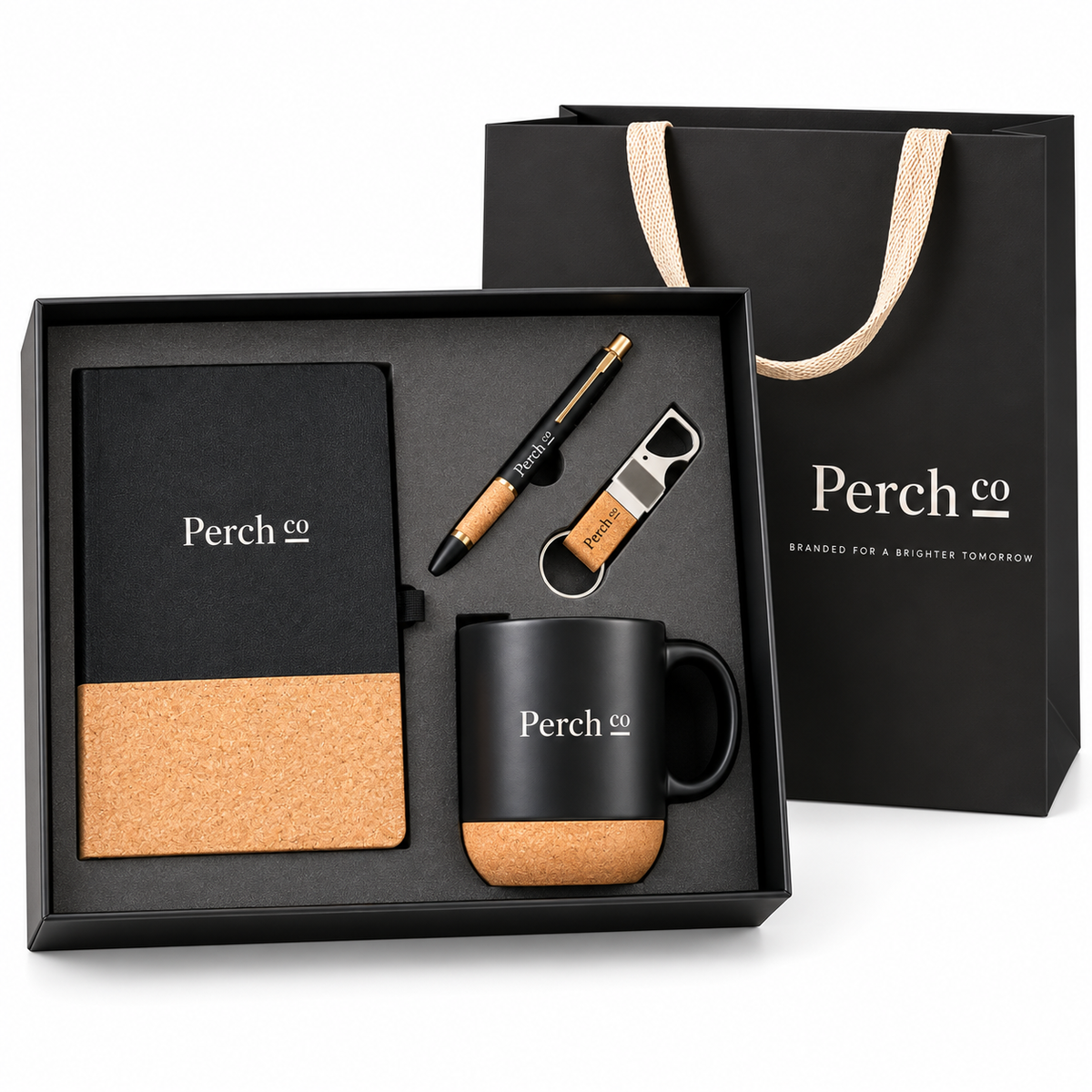 Four-piece gift set: black notebook, pen, bottle-opener keyring and mug with cork detailing, in a black box with carry bag