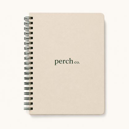 Cream spiral notebook with printed logo