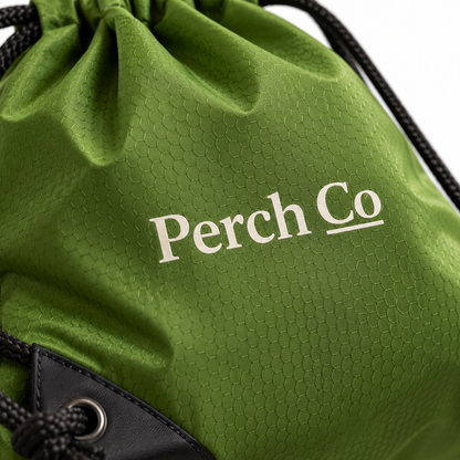 Close-up of the printed logo and reinforced corner eyelet on the drawstring bag