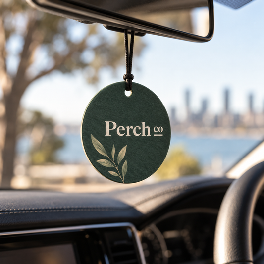 Branded air freshener hanging from a car rear-view mirror
